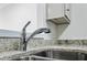 Close-up of kitchen faucet and sink with granite countertop at 24308 Plantation Ne Dr, Atlanta, GA 30324