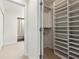 Well-organized walk-in closet with built-in shelving and an adjacent bathroom at 24308 Plantation Ne Dr, Atlanta, GA 30324