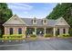 Community pool with stone clubhouse, parking, and ample green space at 235 Rippling Nw Dr, Marietta, GA 30064