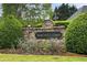 Community sign surrounded by manicured landscaping; welcome to Mcdaniell Farm at 235 Rippling Nw Dr, Marietta, GA 30064