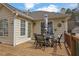 Cozy back deck features a dining table, chairs, and umbrella, ideal for outdoor dining at 3135 Nectar Dr, Powder Springs, GA 30127