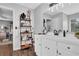 Bright bathroom features modern vanity, mirror, and a storage shelf with a peek into the main bedroom at 3135 Nectar Dr, Powder Springs, GA 30127