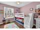 Pink bedroom with a bunk bed and window at 3135 Nectar Dr, Powder Springs, GA 30127