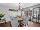 Well-lit dining area with a hardwood floor and a rustic wood table surrounded by upholstered chairs at 3135 Nectar Dr, Powder Springs, GA 30127