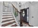 Inviting entryway showcases elegant staircase with dark wood treads and a decorative front door at 3135 Nectar Dr, Powder Springs, GA 30127