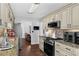 Traditional kitchen with granite countertops, stainless steel appliances, and dark wood flooring at 3135 Nectar Dr, Powder Springs, GA 30127