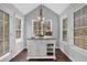 Bright kitchen island with granite countertop and white cabinets surrounded by windows at 3135 Nectar Dr, Powder Springs, GA 30127