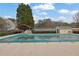 Community pool with covered seating area and a tennis court, perfect for summer recreation at 3135 Nectar Dr, Powder Springs, GA 30127