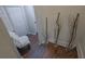 Wooden staircase with adjacent hallway accentuated by decorative branches in glass vases at 3135 Nectar Dr, Powder Springs, GA 30127