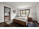 Bedroom with wood bedframe, neutral decor, and a view into the bathroom at 437 Hollydale Nw Ct, Atlanta, GA 30342