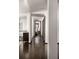 Hallway leads to bedrooms and features hardwood floors and white accents at 437 Hollydale Nw Ct, Atlanta, GA 30342