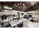 Covered outdoor kitchen and dining area featuring stainless appliances and stone fireplace at 437 Hollydale Nw Ct, Atlanta, GA 30342