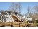 Backyard view of house with deck and stairs to yard, separate living space and garage at 5322 Seaton Dr, Dunwoody, GA 30338