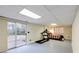 Finished basement with sliding glass door access to the outside, has a treadmill and a bed at 5322 Seaton Dr, Dunwoody, GA 30338