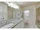 Bright bathroom with double sinks, vanity, and tub-shower combo at 5322 Seaton Dr, Dunwoody, GA 30338