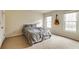 Bedroom with neutral carpet, two windows, and a gray floral comforter at 5322 Seaton Dr, Dunwoody, GA 30338