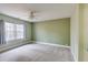 Spacious bedroom featuring neutral carpet, soothing green wall, ceiling fan and double windows letting in natural light at 5322 Seaton Dr, Dunwoody, GA 30338