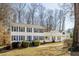 Beautiful two-story home with white siding, blue shutters, and manicured landscaping at 5322 Seaton Dr, Dunwoody, GA 30338