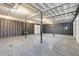 Spacious unfinished garage with high ceilings, concrete floor and two garage doors at 5322 Seaton Dr, Dunwoody, GA 30338