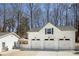 Detached three-car garage with white doors and a matching adjacent outbuilding at 5322 Seaton Dr, Dunwoody, GA 30338