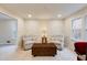 Cozy living room with neutral walls, two upholstered chairs and a vintage trunk table at 5322 Seaton Dr, Dunwoody, GA 30338