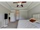 Spacious main bedroom featuring a tray ceiling and an adjacent doorway at 1665 Windsong Park Dr, Dacula, GA 30019