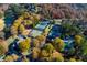 Aerial view of community clubhouse, pool, and tennis courts surrounded by fall foliage at 2001 Towne Lake W Hls, Woodstock, GA 30189