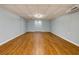 Unfinished basement area with wood-look flooring and neutral paint at 2001 Towne Lake W Hls, Woodstock, GA 30189