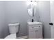 Powder room featuring a pedestal sink and toilet at 2001 Towne Lake W Hls, Woodstock, GA 30189