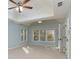 Bedroom with tray ceiling, a ceiling fan, and large windows at 2001 Towne Lake W Hls, Woodstock, GA 30189