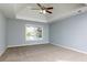 Spacious bedroom with tray ceiling and large window overlooking the backyard at 2001 Towne Lake W Hls, Woodstock, GA 30189