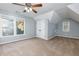 Upstairs bedroom boasts cozy carpet, natural lighting and neutral paint at 2001 Towne Lake W Hls, Woodstock, GA 30189