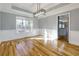 Bright dining room features hardwood floors, wainscoting, and modern chandelier at 2001 Towne Lake W Hls, Woodstock, GA 30189