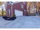 Spacious driveway leading to a two-car garage with manicured landscaping at 2001 Towne Lake W Hls, Woodstock, GA 30189