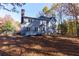 Exterior back elevation with deck and natural surroundings at 2001 Towne Lake W Hls, Woodstock, GA 30189