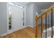Bright foyer with hardwood floors, staircase, and natural light from sidelight windows at 2001 Towne Lake W Hls, Woodstock, GA 30189