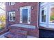 Inviting brick home featuring a charming front door framed by sidelights and decorative molding at 2001 Towne Lake W Hls, Woodstock, GA 30189