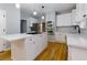Bright kitchen with stainless appliances, a large island, and classic white cabinets at 2001 Towne Lake W Hls, Woodstock, GA 30189