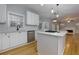 Kitchen with stainless appliances, a large island, and an open view of the living room at 2001 Towne Lake W Hls, Woodstock, GA 30189