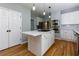 Bright kitchen featuring a center island, stainless steel appliances, and modern finishes at 2001 Towne Lake W Hls, Woodstock, GA 30189