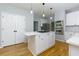 Updated kitchen features stainless appliances, a large island, and ample storage at 2001 Towne Lake W Hls, Woodstock, GA 30189