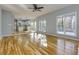 Open concept living space with wood floors and view into modern kitchen with white cabinets at 2001 Towne Lake W Hls, Woodstock, GA 30189
