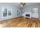 Living room with fireplace, built-in shelving, hardwood flooring, and natural light at 2001 Towne Lake W Hls, Woodstock, GA 30189