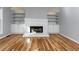 Living room with fireplace, built-in shelving, and hardwood flooring at 2001 Towne Lake W Hls, Woodstock, GA 30189