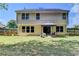 Exterior view of backyard with mature trees, wooden fence, lush lawn and patio with furniture at 1171 Pine Acre Dr, Sugar Hill, GA 30518