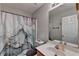 Bathroom vanity with a white sink, a marble designed shower curtain, and a mirror at 1171 Pine Acre Dr, Sugar Hill, GA 30518