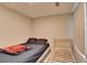 This bedroom features a black platform bed, a red blanket, a neutral wall, and a carpet floor at 1171 Pine Acre Dr, Sugar Hill, GA 30518