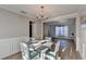 Traditional dining room with wainscoting and a stylish chandelier at 1171 Pine Acre Dr, Sugar Hill, GA 30518