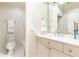 Well-lit bathroom featuring a white vanity, sink, and tiled walk-in shower at 3448 Paces Ferry Cir, Smyrna, GA 30080