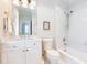 Bright bathroom featuring a vanity with gold hardware, toilet, and a shower-tub combination with white tile surround at 3448 Paces Ferry Cir, Smyrna, GA 30080